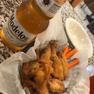 a bottle of beer and a basket of fried chicken