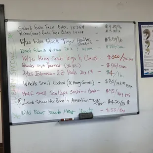 a whiteboard with a price list on it