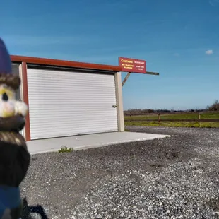 a gnome statue in front of a garage