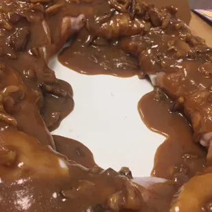 Signature pecan praline sauce over our delectable king cake.