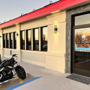 a motorcycle parked in front of a restaurant