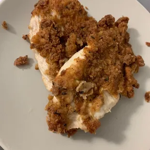 Fried chicke breast pieces. Some of the breading fell off.