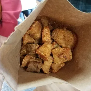 a person holding a bag of cajun meat