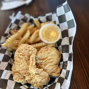 a basket of fried fish and fries