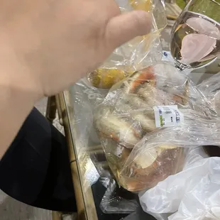 a person grabbing a sandwich from a tray
