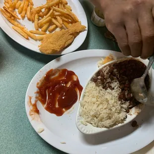 a plate of mexican food and a plate of french fries