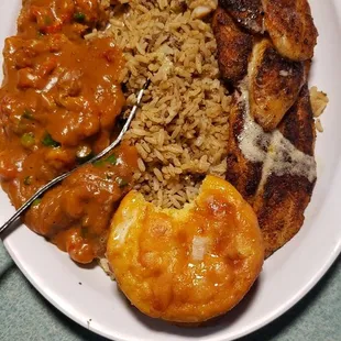 Blackened Tilapia and Crawfish etouffee With Cajun rice. Jalapeno cornbread.