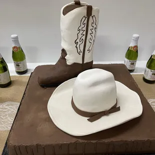 a cowboy hat, boots, and bottle of wine