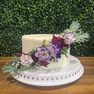 a white cake with purple and white flowers