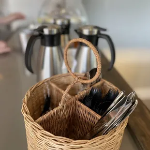 a wicker basket with utensils in it