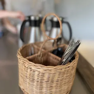 a basket of utensils on a counter