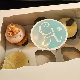 a box of cupcakes with frosting