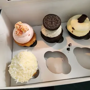 a variety of cupcakes in a box