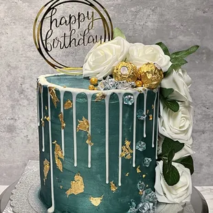 a cake with drips and flowers