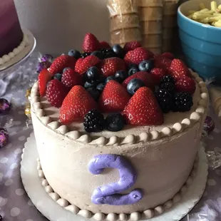 Chocolate cake with almond filling and number 2 on side. Added fruit toppings at home.