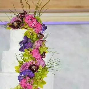 Beautiful 4-tier wedding cake with orchids and roses by Debra at Cake Connection