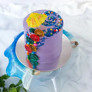 a purple cake with colorful decorations