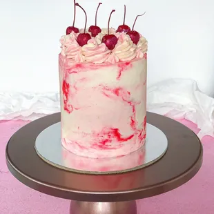 a cake with cherries on top