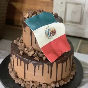 a mexican flag on top of a chocolate cake