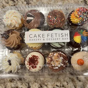 a variety of cupcakes in a plastic container