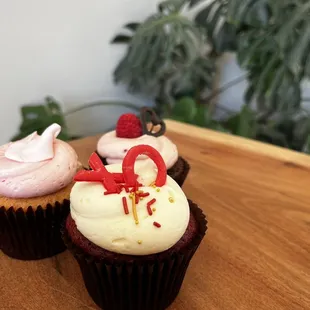 three cupcakes on a wooden table