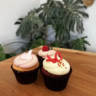 two cupcakes on a wooden table