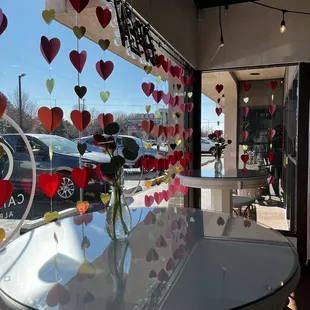 a vase of roses and hearts on a table