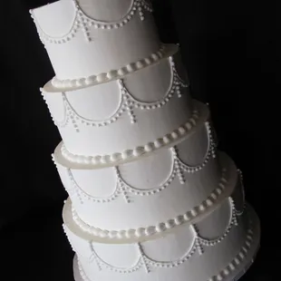 4 tier round buttercream wedding cake with hand piping