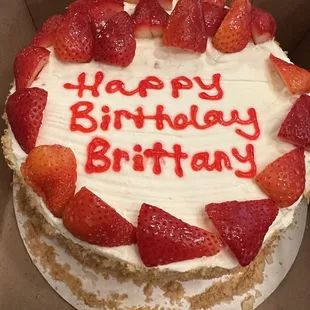 a birthday cake with strawberries on top