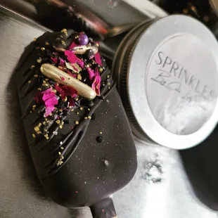 a chocolate covered ice cream with sprinkles