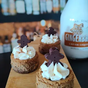 a wooden cutting board topped with mini cupcakes