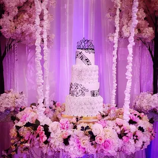 a wedding cake surrounded by flowers
