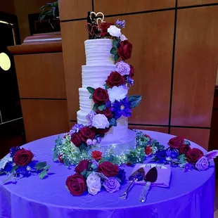 Wedding cake with four flavors, textured vanilla buttercream on the outside, and a flower cascade