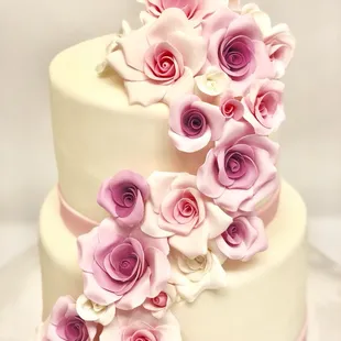 An all edible sugar flowers cake to welcome a little baby girl .