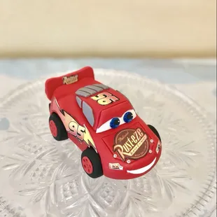 An edible lightning McQueen cake topper handcrafted with love for a little fan