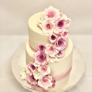 An all edible sugar flowers cake to welcome a little baby girl .