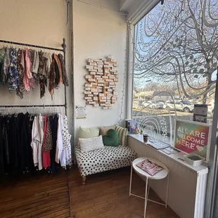 Interior of the store featuring a comfortable sitting area, reading material, and flyers