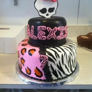 a three tiered cake with a skull on top
