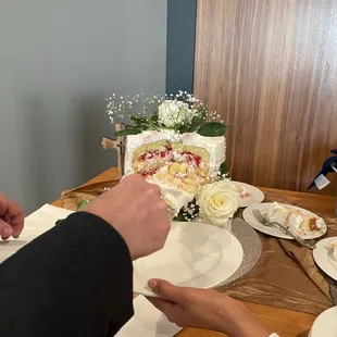 a man and a woman cutting a cake