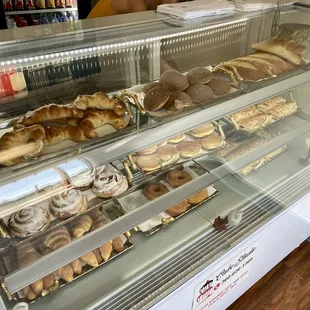 a display case with a variety of pastries