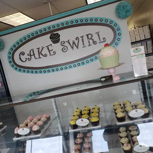 a display of cupcakes and pastries