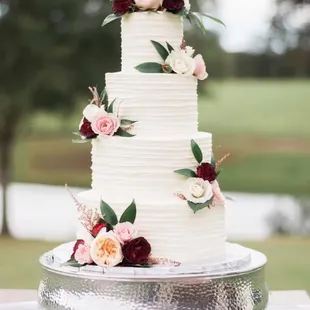a wedding cake with flowers on top