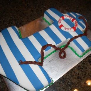 a blue and white cake with a life preserver