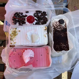Cake slices: black forest (top), rasmalai (middle), falooda (bottom), tiramisu (right)