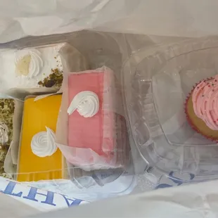 two cupcakes in plastic containers