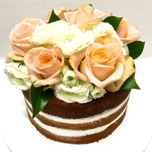 Naked cake with roses on top.
