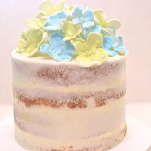 Simple naked cake with flowers on top.