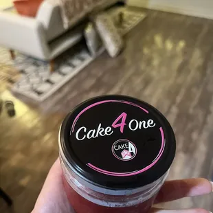 a hand holding a cup of cake 4 one