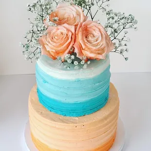 a three tiered cake with roses on top