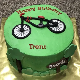 a bicycle on a green cake